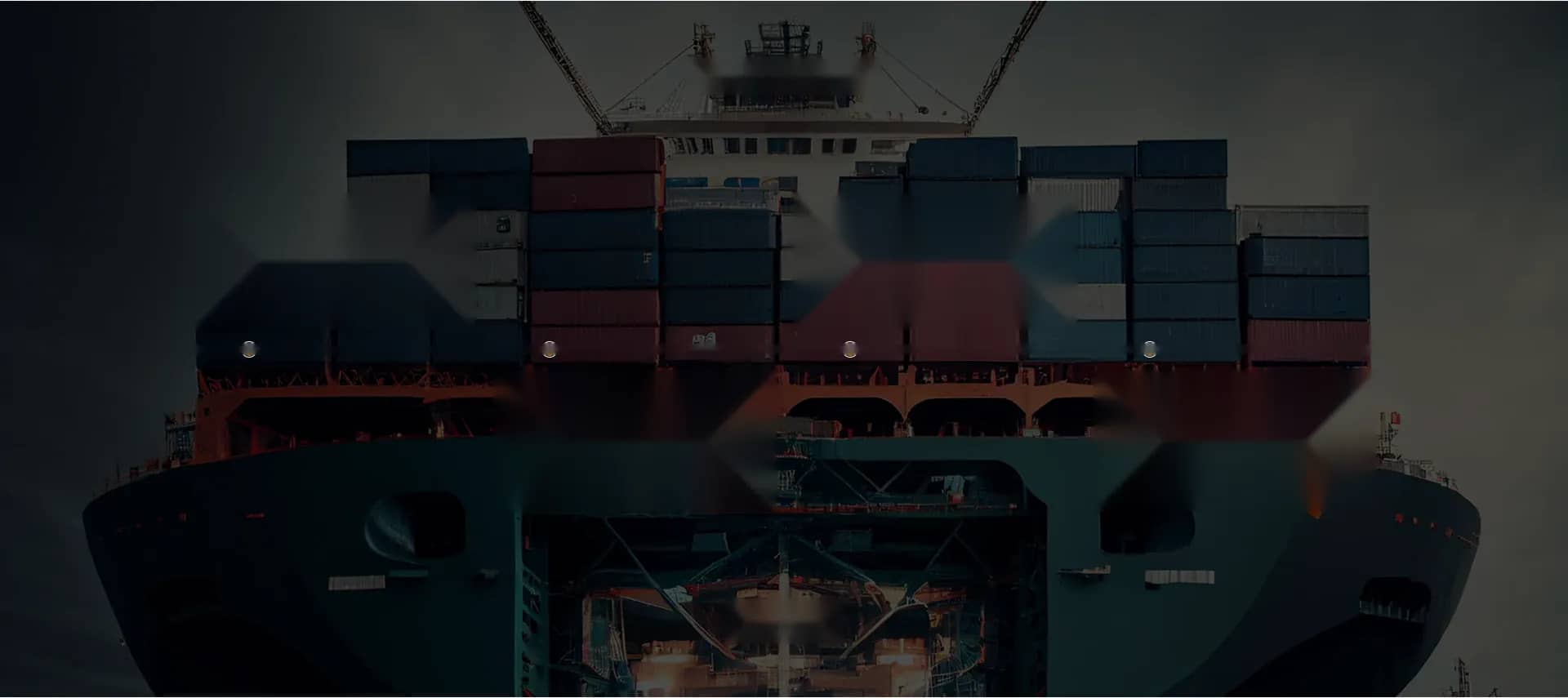 Container ship docked at a port terminal at night