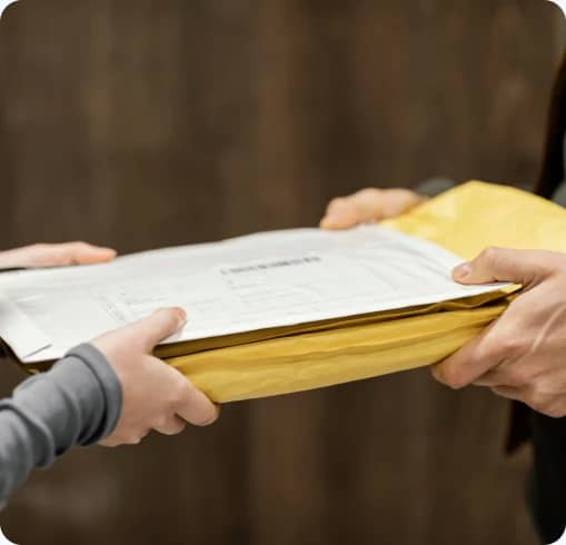 Shipping documents in an envelope being handed over