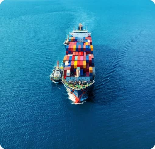 Aerial view of a fully loaded container ship sailing on open sea