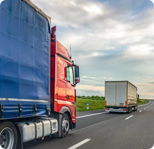Red container trucks driving along a highway